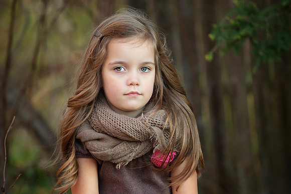 portrait of a beautiful four year old girl with long hair on a warm autumn day